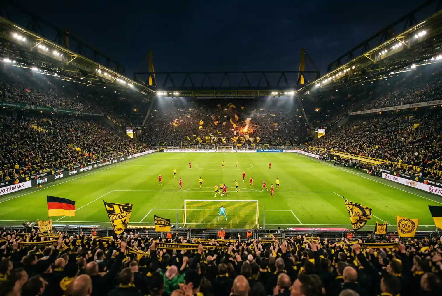 Estadio de la Bundesliga durante un partido nocturno con gradas llenas de aficionados